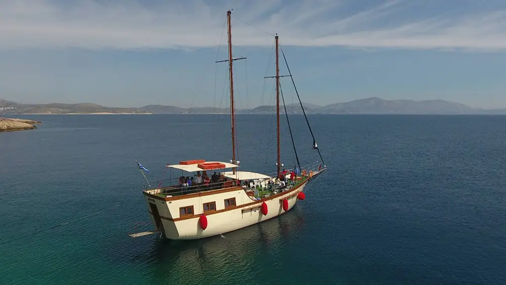 Traditional wooden sailing ship on a calm Greek sea during a group cruise