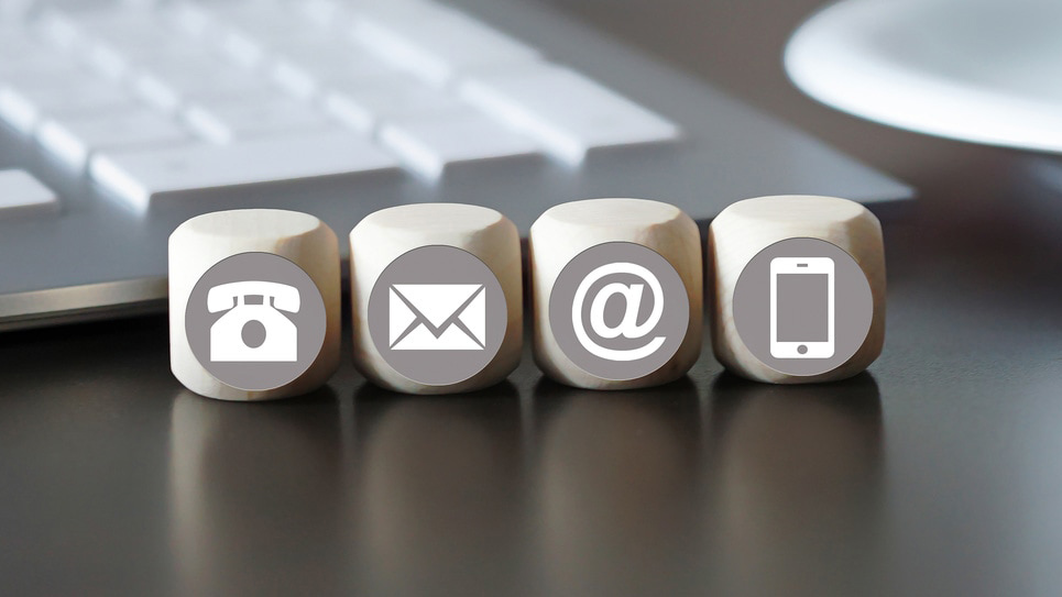 Wooden blocks with phone, email and mobile icons for contacting One Event