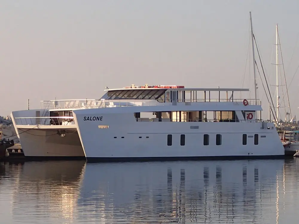 Salone motor catamaran moored in a marina, used for private group cruises